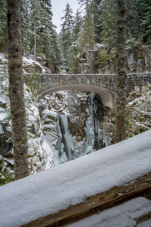 Brdige At Christine Falls Framed By Snowy Trees during winterの写真素材