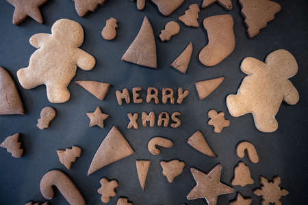 Merry Christmas Message in Gingerbread with cookies surrounding itの写真素材