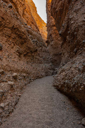 Narrow Pathway Snakes Through The Tall Walls of Sidewinder Canyon in Death Valley National Parkの写真素材