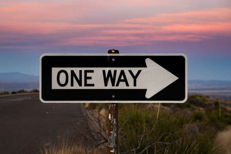 Sunrise Colors Light Up One Way Only Sign in Big Bend National Parkの写真素材