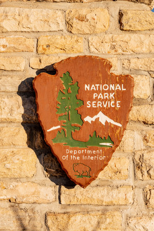 Carlsbad Caverns National Park, United States: January 30, 2021: Weathered National Park Sign on Yellow Stone Wallのeditorial素材