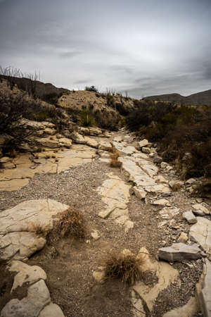 Dark Clouds Hang Over Rocky Dry Wash in Big Bend National Parkの写真素材