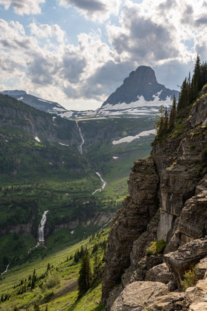 Waterfall Tumbles out of Logan Pass into Valley in Glaicer National Parkの写真素材