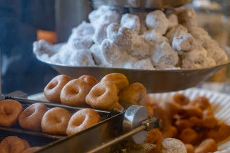Close up of Mini Donuts on Vintage Frying Machine in public marketの写真素材