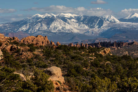 The La Sal Mountains Loom High Over The Fiery Furnace In Arches National Parkの写真素材