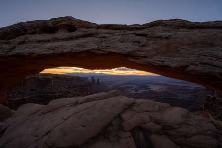 Mesa Arch Frames Morning Light Breaking over the La Sal mountains in the distance