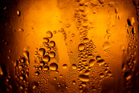 Multiple Water Droplet Texture on Orange Bottleの写真素材