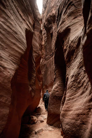 Hiker Walking Through Wire Pass Slot Canyon on the way to Buckskin Gulchの写真素材