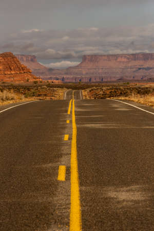 Road Drops into Canyonlands on Cloudy day in Utahの写真素材