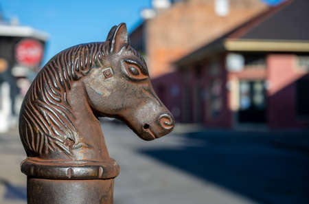 Rusty Horse Head Post with blurry city backgroundの写真素材