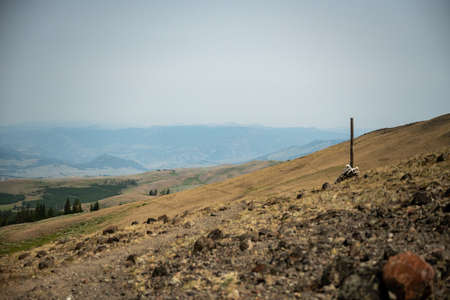 Lone Trail Marker Along Specimen Ridge With The Real Trail and Two Animal Trails On The Distant Hill...