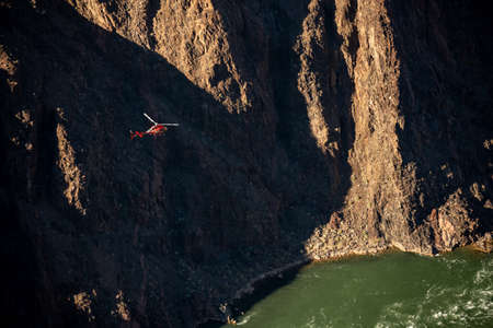 Looking Down On Tour Helicopter Above The Colorado River In The Grand Canyon disrupting the sounds of natureの写真素材