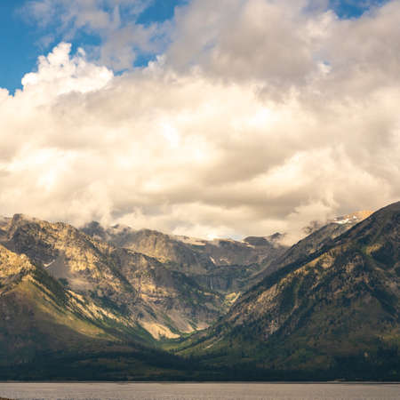 Thick Clouds And Golden Light Gather Over Waterfalls Canyon in Grand Teton National Parkの写真素材