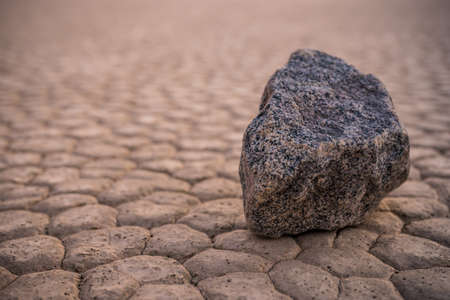 Single Sailing Stone Sits On The Dry Lake Bed of Racetrack Playa in Death Valley National Parkの写真素材