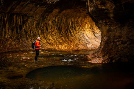 Woman Pauses to Look at the Subway Canyon formatiion in Zion National Parkの写真素材