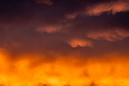 Sunrise Paints A Gradient Of Purple To Orange Over The Clouds in Arches National Parkの写真素材