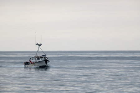 Fisherman Stands On The Back Of Troller in the Santa Barbara Channelの写真素材