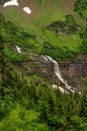 Bright Greens Surrounding Morning Eagle Falls below Piegan Pass in Glacier National Parkの写真素材