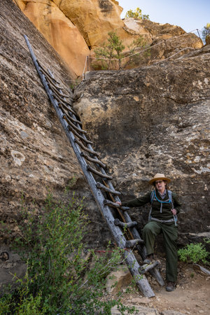 Mesa Verde National Park, United States: June 1, 2022: Ranger Stands at Bottom of Wooden Ladder on Cliff Dwelling Tourのeditorial素材