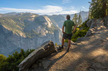 Man Takes in the View from the Four Mile Trail in Yosemite National Parkの写真素材