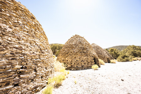 Charcoal Kilns Sit Unused in Death valley National Park with bright lightの写真素材