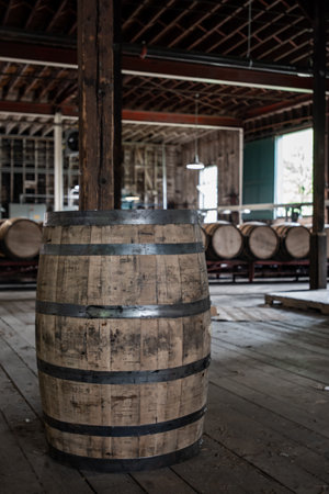 Single Bourbon Barrel Stands Alone in warehouse roomの写真素材