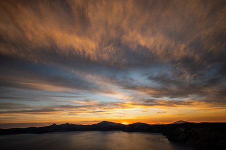 Dramatic Clouds Catch The Last Light At Sunset Over Crater Lake National Parkの写真素材