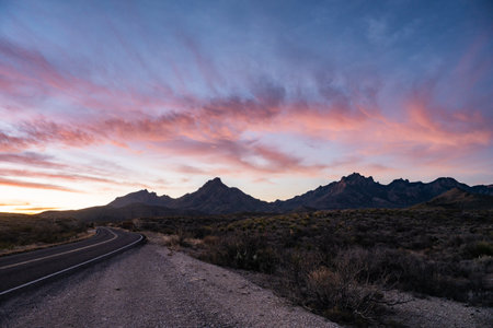 Light Pink Clouds Hang Over The Chisos Mountains At Sunrise in Big Bend National Parkの写真素材