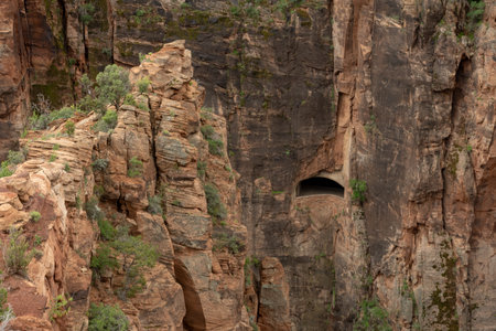 Large Rock Outcropping Looks Over Window Into Mt Carmel Tunnel in Zionの写真素材