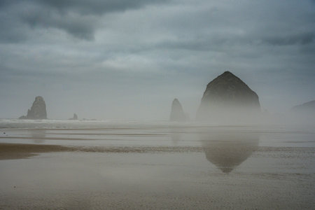 Moody Fog Lingers Over Cannon Beach on the Oregon Coastの写真素材