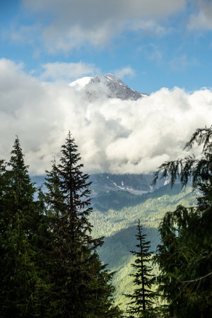 Narrow Band Of Clouds Block Out Most Of Mount Rainier With Only The Top Visible as storm clearsの写真素材