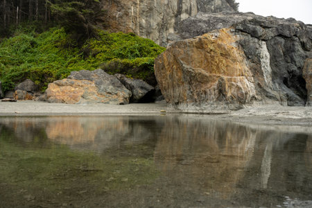 Tidal Pool At The Base Of Large Rocks On the Coastal Trail At Low Tide on the Oregon Coastの写真素材