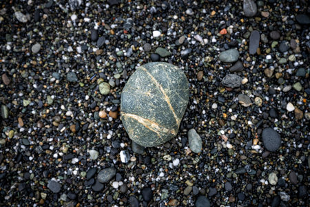 Tan Stripes Across Gray Rock on Rocky Beachの写真素材