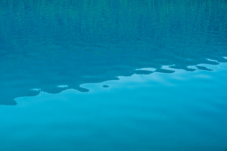 Aquamarine Waters of Bowman Lake with subtle ripples in Glacier national Parkの写真素材