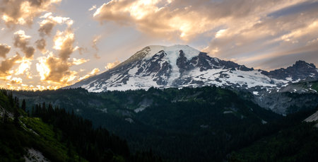 Golden Clouds Fill The Sky Over Snow Covered Mount Rainier National Park