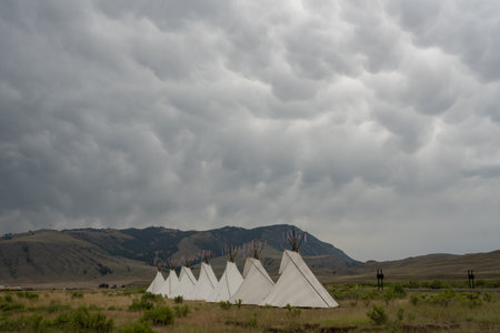 Seven Teepees Stand Tall Below Dramatic Storm Clouds In Gardiner, Montana