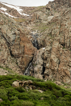 Waterfall Tumbles Over Cliff Walls into Crystal Lakes in Rocky Mountain National Parkの写真素材