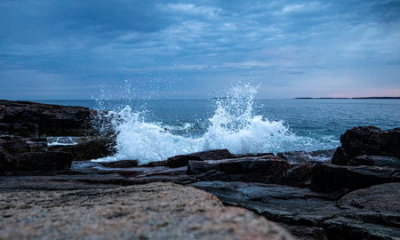 Crashing Wave On The Rocky Coast Of Maine With Evening Color In The Distance in Acadia National Park