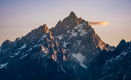 Evening Light Warms The Peaks Of Grand Teton Summitの写真素材