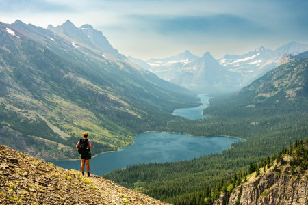 Hiker On Bear Mountain Looks Out At Cosley Lake In The Backcountry Of Glacier National Park