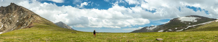 Sweeping Panorama Of Hiker On Top Of The Saddle in Rocky Mountain National Park
