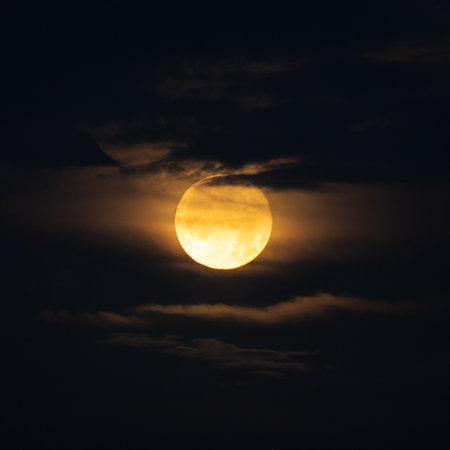 Full Moon Surrounded By Clouds Looks Like An Eye in night skyの写真素材