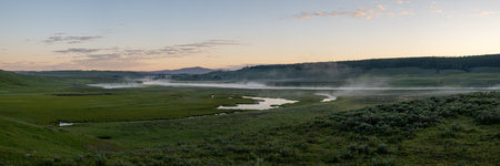 Panorama Of Morning Fog Hanging Over The Yellowstone River And Hayden Valley in Summerの写真素材