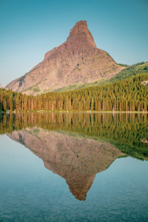 Mount Gedhun Reflects in the Calm Waters of Grace Lake in Glacier National Parkの写真素材