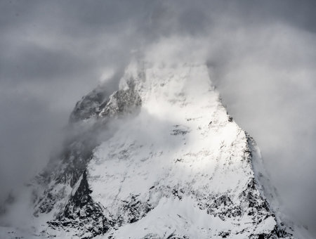Moody Clouds Cling To The Jagged Cliffs Of The Matterhorn Summitの写真素材
