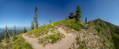 Numa Ridge Lookout Tower Sits on Peak on Blue Sky Day in Glacier National Park