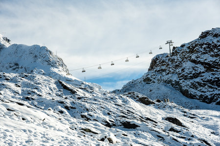 Ski LIft Climbs Hill Over First Snow Of The Year in the Swiss alpsの写真素材