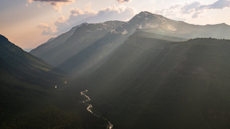 Rays Of Light Cascade Down The Mountainsides of Glacier National Park
