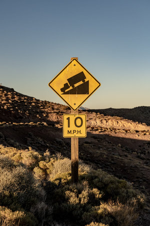 Steep Grade 10 Miles Per Hour Sign on remote road in Death Valley National Parkの写真素材