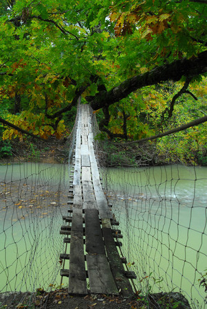 Old Wooden Swinging Bridge In Arkansas Over Mulberry Riverの写真素材